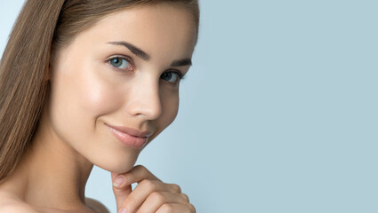 Portrait of beauty model with natural make up, formed eyebrows and long eyelashes. Beautiful young smiling woman with clean perfect fresh skin. Spa, skincare and wellness