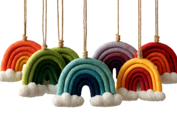 Vibrant knitted rainbow decorations with fluffy white clouds, perfect for nursery or bohemian decor, creating a cheerful and whimsical atmosphere for any celebration.