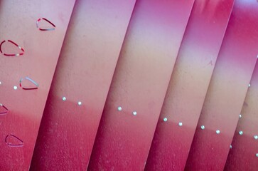 A series of pink and orange stripes with a heart in the middle. The stripes are arranged in a...