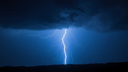 A dramatic lightning strike illuminates the dark stormy sky with electric blue brilliance.