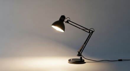 Black Adjustable Desk Lamp with Warm Light on Plain Background