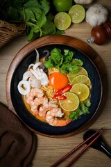 Tom yum with noodles , thai style instant spicy noodles with shrimp and egg,squid , noodles tom yum with shrimp and egg,squid