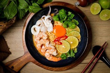 Tom yum with noodles , thai style instant spicy noodles with shrimp and egg,squid , noodles tom yum with shrimp and egg,squid