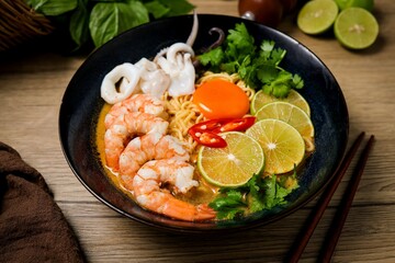 Tom yum with noodles , thai style instant spicy noodles with shrimp and egg,squid , noodles tom yum with shrimp and egg,squid
