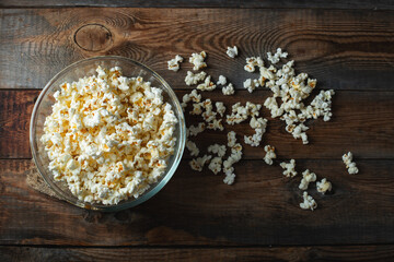 Pop corn on wood color background.Food and snack concepts ideas.Minimal style top view mockup