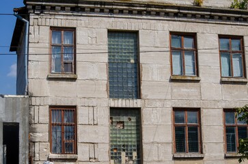 A large building with many windows and a large window in the middle. The building is old and has a...