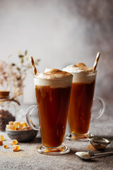 Iced coffee in a tall glasses with cream poured over
