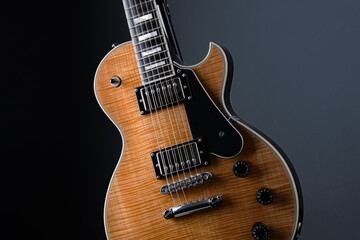  Electric guitar with natural pattern isolated on black background.