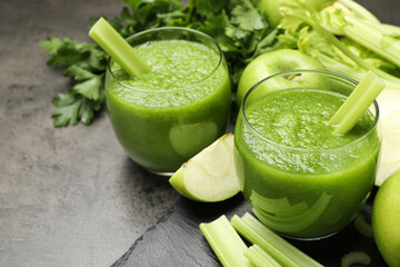 Superfood. Refreshing smoothie in glasses and apples on dark textured table, closeup