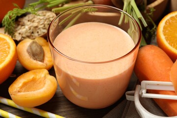Superfood. Tasty smoothie in glass and ingredients on wooden table, closeup