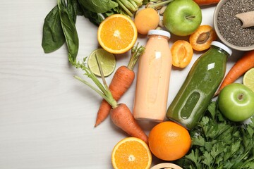 Superfood. Bottles with tasty smoothies and ingredients on light wooden table, flat lay