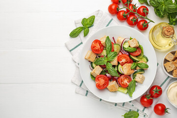 Delicious salad with croutons and ingredients on white wooden table, flat lay. Space for text