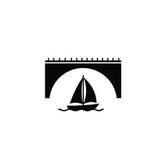 Black sailboat passes under arched bridge white