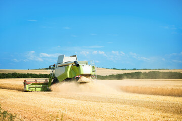 Modern combine harvester working in wheat field