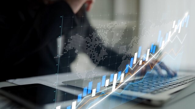 A business professional works on a laptop, focusing on financial data. A dynamic stock market graph overlays the scene, emphasizing growth and analysis in a contemporary office. Copula - Powered by Adobe