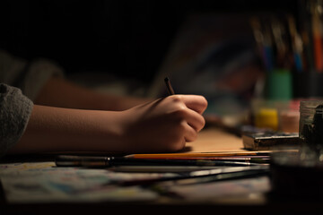 Hands drawing or painting, art supplies around, creativity, drawing, painting, solitude, hobbies.