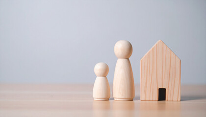 A tender scene capturing the essence of family and home, with wooden figurines representing a parent and child alongside a charming house