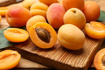 Many fresh apricots on wooden table, closeup