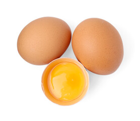 Whole and broken chicken eggs isolated on white, top view