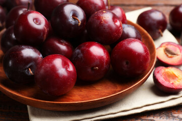 Ripe cherry plums on wooden table, closeup
