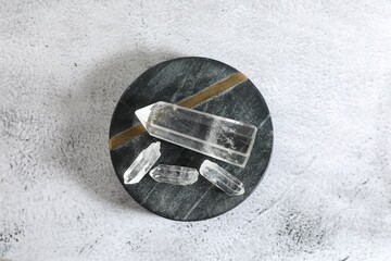 Aura. Beautiful crystals on white textured table, top view
