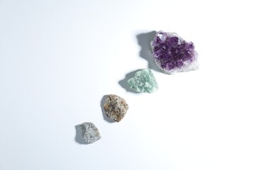 Aura. Different natural mineral stones on white background, flat lay