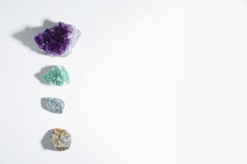 Aura. Different natural mineral stones on white background, flat lay. Space for text