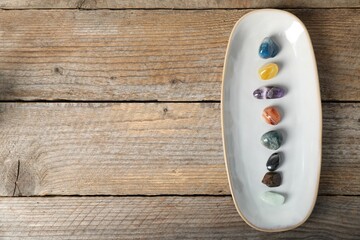 Aura. Different natural mineral stones on wooden table, top view. Space for text