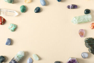 Aura. Different natural mineral stones on beige background, flat lay. Space for text