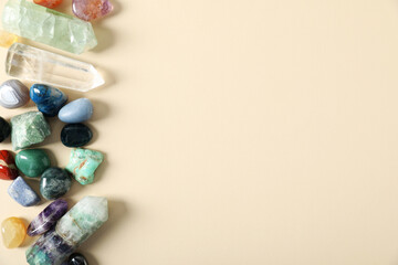 Aura. Different natural mineral stones on beige background, flat lay. Space for text