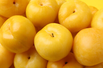 Many ripe yellow cherry plums as background, closeup