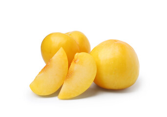 Whole and cut yellow cherry plums isolated on white