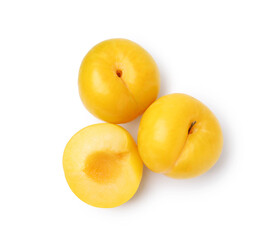 Whole and cut yellow cherry plums isolated on white, top view