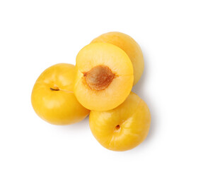 Whole and cut yellow cherry plums isolated on white, top view