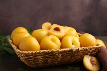 Ripe yellow cherry plums on wooden table, closeup. Space for text