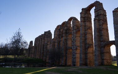 Ancient Aqueduct Ruins in Merida, Spain Under Clear Sky