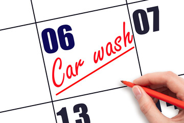 6th day of the month.  Hand writing Car wash reminder and drawing a line on calendar with red pen...