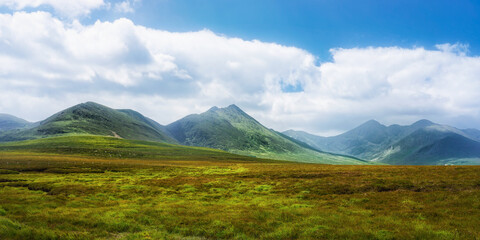 Fototapeta premium A stunning view of Ireland's rugged and beautiful landscape, green hills and mountains meeting the sky.