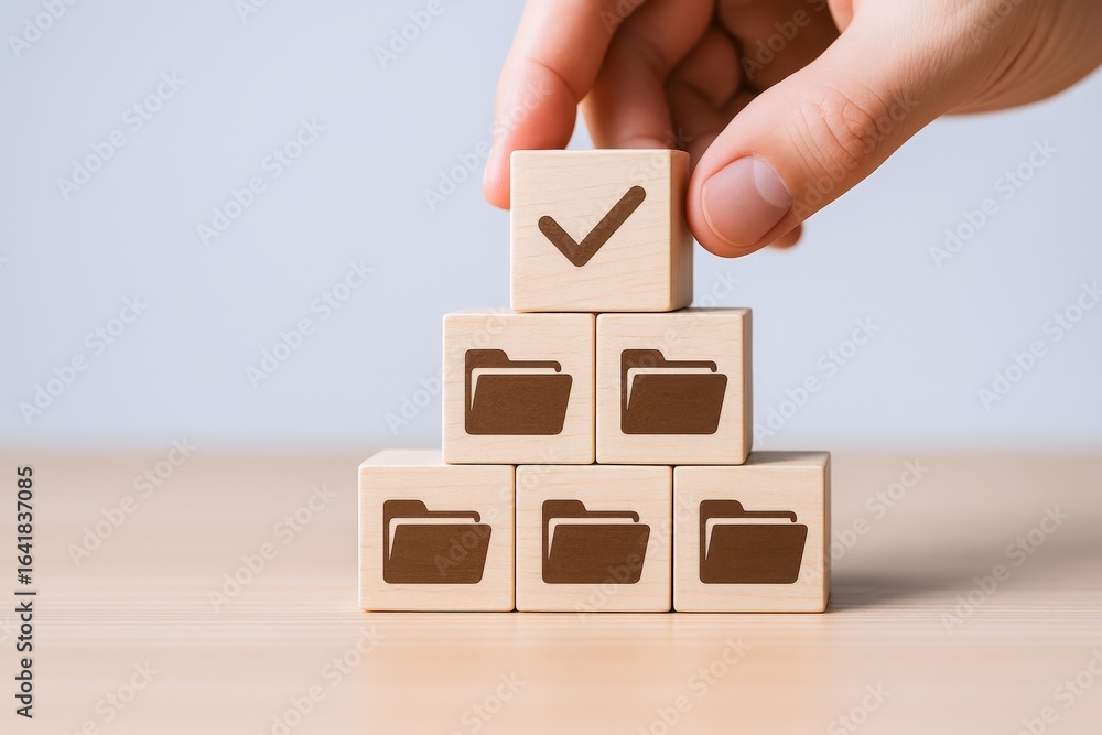 Poster data management concept: hand placing check mark block on top of folder icons stack