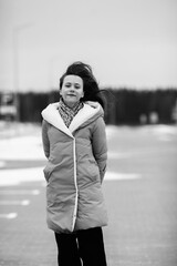Portrait of a young beautiful long-haired girl outdoors in winter.