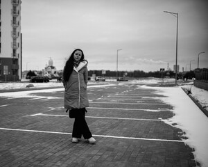 Portrait of a young beautiful long-haired girl outdoors in winter.