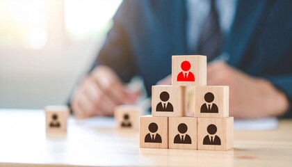 A visual representation of leadership and hierarchy using wooden blocks, with one block highlighted in red