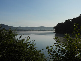 The peaceful tranquility of Middle Creek lake, with morning fog across the calm, reflective water. Middle Creek Wildlife Management Area, Lancaster County, Pennsylvania.  