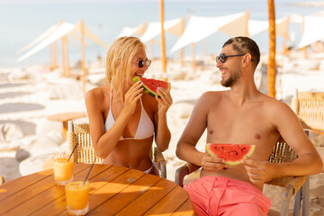 Enjoying summer vibes with watermelon at the beachside cafe in daytime