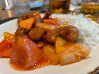 Close up of baked pieces of meat served on white plate