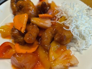 Close up of baked pieces of meat served on white plate