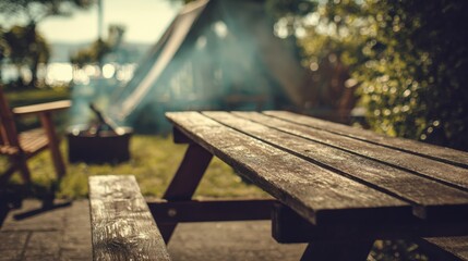 Fototapeta premium Rustic Wooden Picnic Table with Campfire Smoke in Outdoor Recreation Area for Relaxation and Leisure