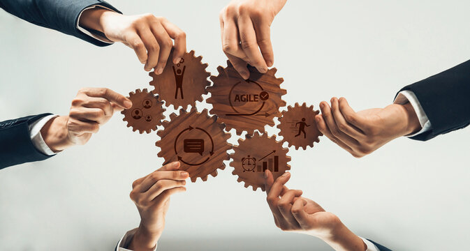Fototapeta This image depicts a diverse team of professionals collaborating with gears, symbolizing agile methodology and effective teamwork in a business environment. Amity