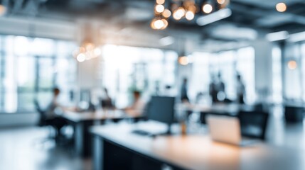 A blurry image of a busy office with people working at their desks. Scene is busy and professional