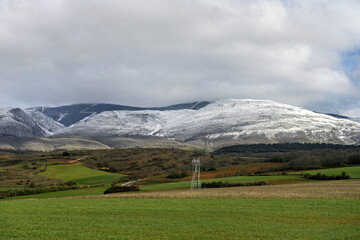 Snow-dusted mountains and rolling fields in Palencia, Spain
